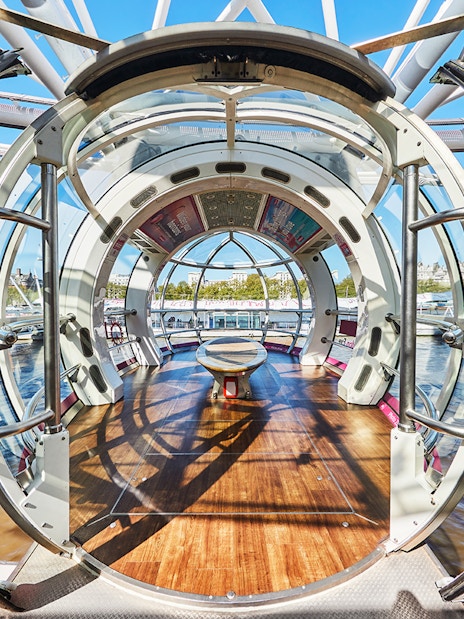 London Eye pod overlooking Thames River and cityscape.