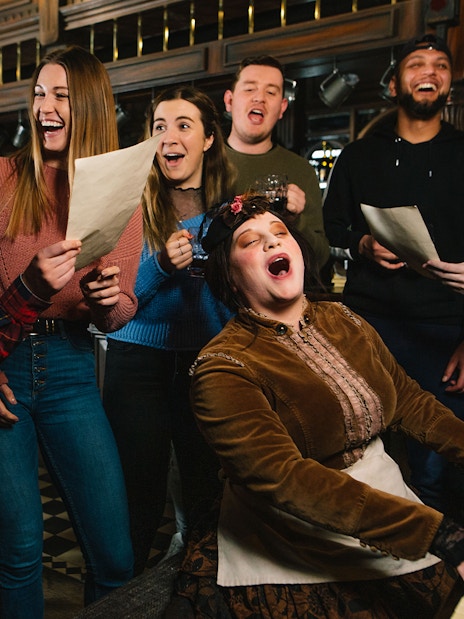 Visitors enjoying a historical tavern experience at the London Dungeon.