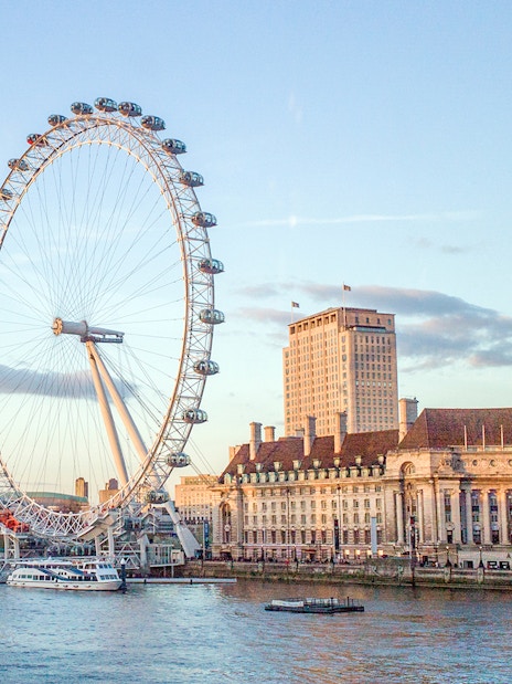 London Eye viewed from a river cruise on the Thames River, London.