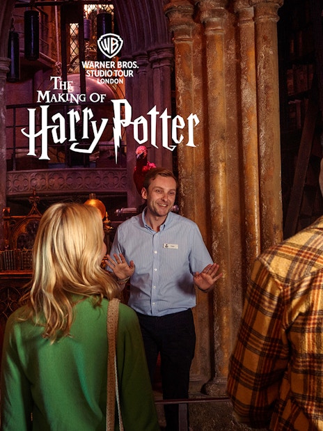 Guided tour group at Warner Bros Studio London exploring Harry Potter film sets and props.