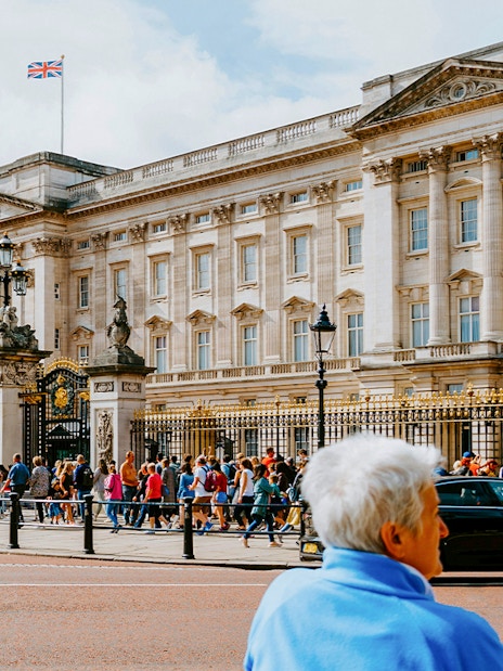 Buckingham Palace exterior with tourists in front, London.
