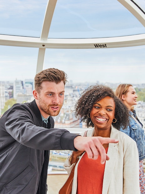 Visitors on the London Eye overlooking the cityscape of London.