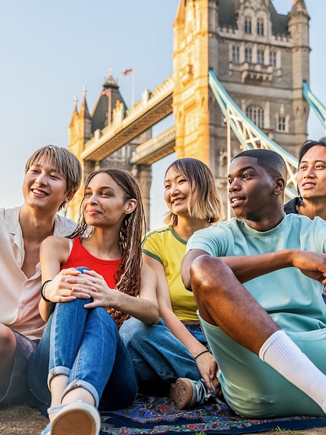 Tourists on Tower Bridge viewing London's skyline, showcasing exclusive access with Tower Bridge tickets.