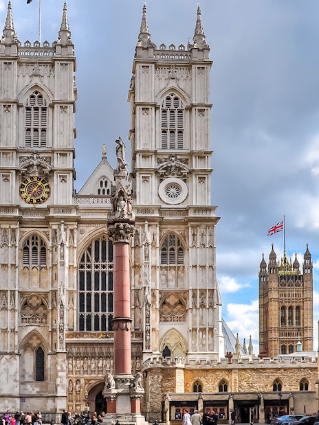 Westminster Abbey exterior with tourists in London.