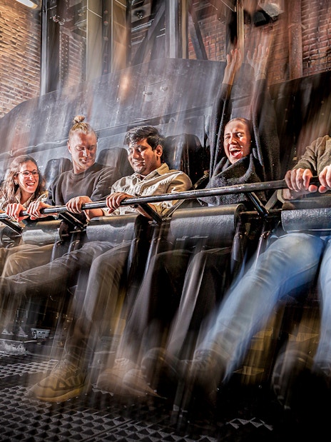 Visitors experiencing the Drop Dead Ride at London Dungeon, featuring a thrilling free-fall drop.