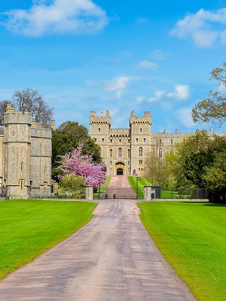 Windsor Castle exterior with tourists exploring the historic site in London.