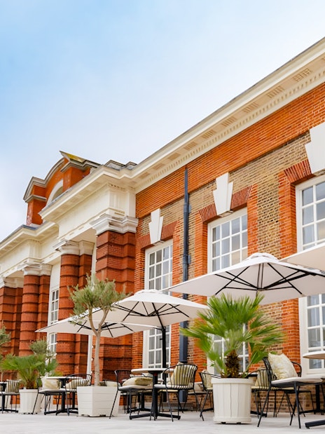 Kensington Palace orangery set for Royal Afternoon Tea with elegant table settings.