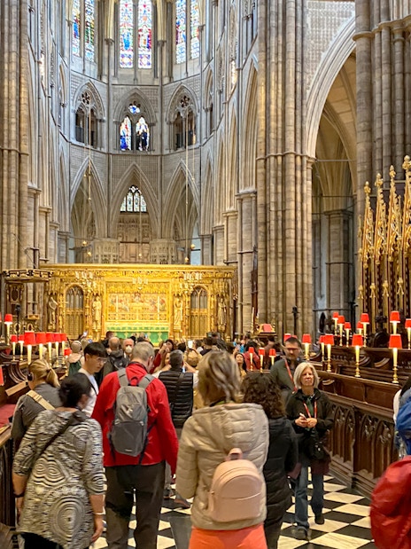 Visitors exploring the historic interior of Westminster Abbey, London.