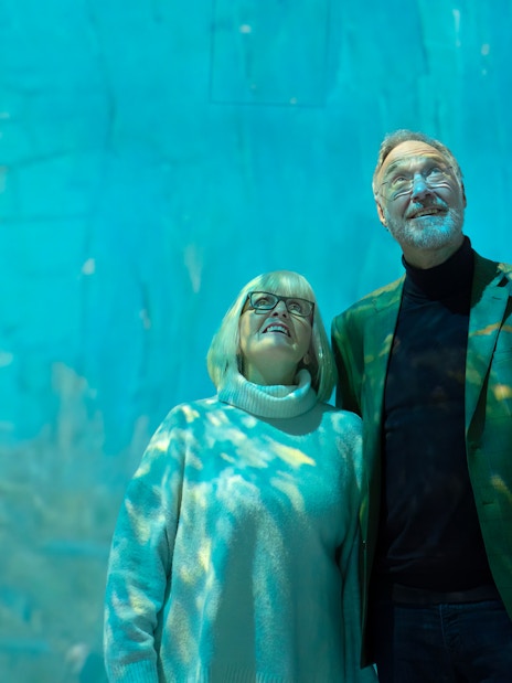 Visitor observing art installation at Beyond Reality gallery exhibit.