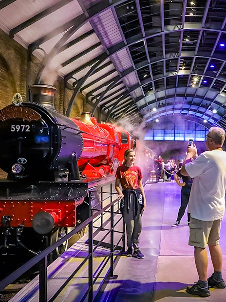 Tourists photographing the Hogwarts Express at Warner Bros. Studio, London.