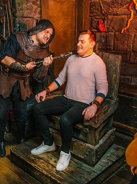 Visitors in the Torture Chamber at Harry Potter Warner Bros. Studio Tour, London Dungeon combo.