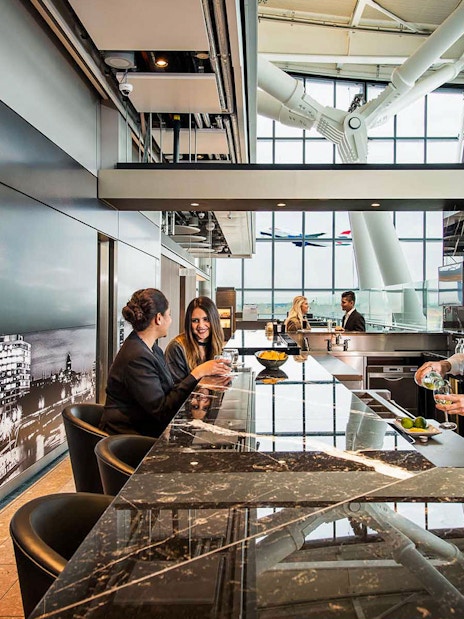 Travellers inside Plaza Premium Lounge at Heatherow airport, London