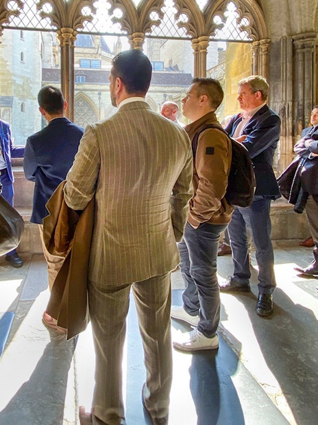 Tourist listening to guide inside Westminster Abbey, London.