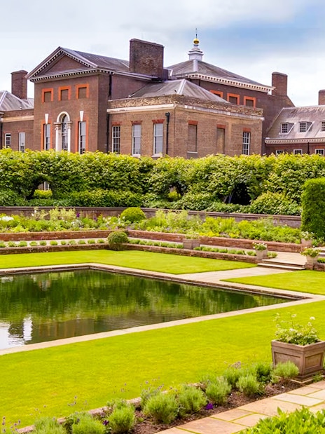 Kensington Palace Sunken Garden with vibrant flowers and historic architecture in London.