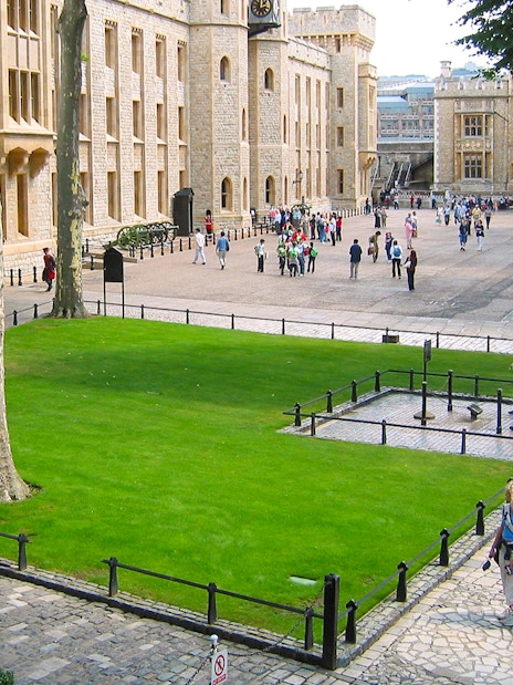 Tower of London execution block with Beefeater guiding early access tour group