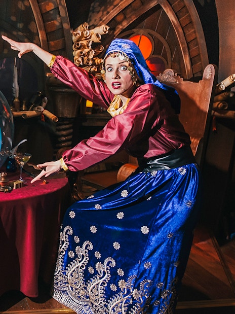 Visitors enjoying interactive Shrek's Adventure! London Tickets tour, featuring Shrek characters and London cityscape