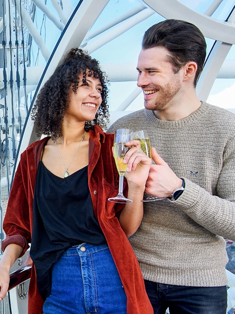 Guests enjoying the London Eye Champagne Experience with a stunning view of the city skyline at sunset