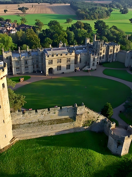 Warwick Castle with lush gardens, part of Stratford, Oxford, Cotswolds & Warwick Castle Tour with Lunch.