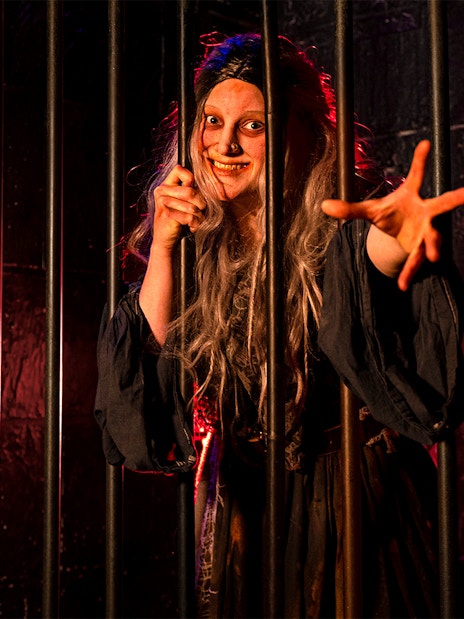 Witches role play in London Dungeon with actors in period costumes performing a historical scene.