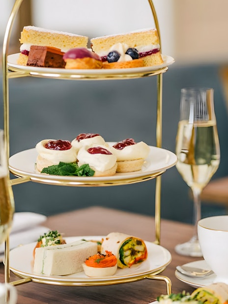 Kensington Palace afternoon tea setup with elegant tableware and pastries.