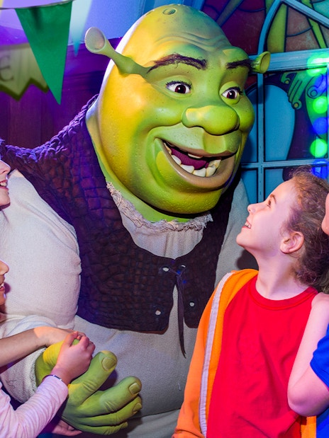 Visitors enjoying the interactive Shrek's Adventure! London tour, a unique family-friendly attraction in London