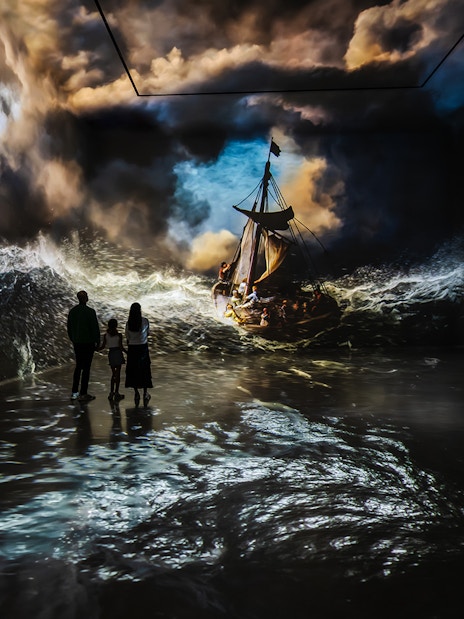 Visitors exploring digital art installations at Frameless London: Immersive Art Experience.