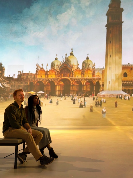 Visitor observing art installation at "The World Around Us" gallery exhibit.