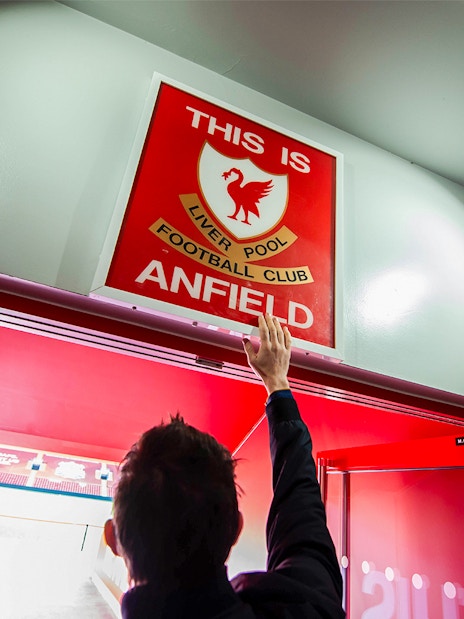 Visitors exploring the iconic Liverpool FC Stadium during the guided tour, with Museum Entrance Tickets included