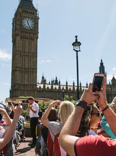 Big Bus tour passing by Big Ben in London.