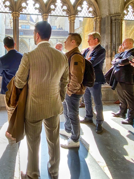 Tourist listening to guide inside Westminster Abbey, London.