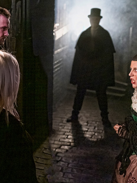 Jack the Ripper exhibit in London Dungeon with historical artifacts and dimly lit atmosphere.