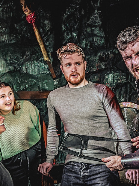 Guests exploring the Torture Chamber exhibit at London Dungeon, England.