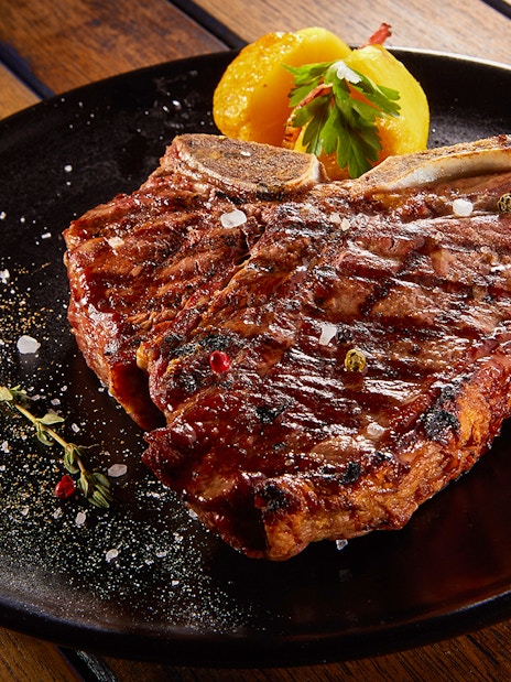 Blenheim Palace gardens with tourists exploring, Cotswolds day trip, England.