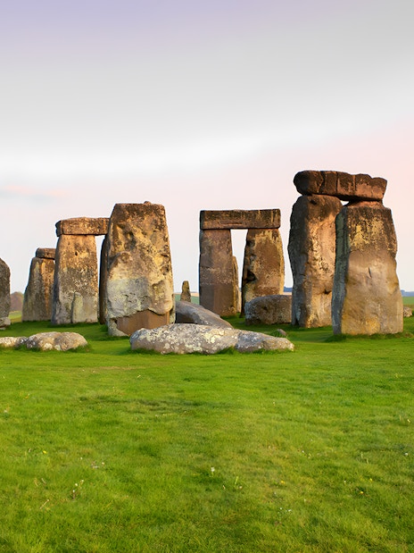 Stonehenge ancient stone circle in Wiltshire, England, under a clear sky.