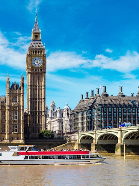 Tootbus passing Big Ben and Houses of Parliament on London Hop-On-Hop-Off Bus Tour with Thames River Cruise.