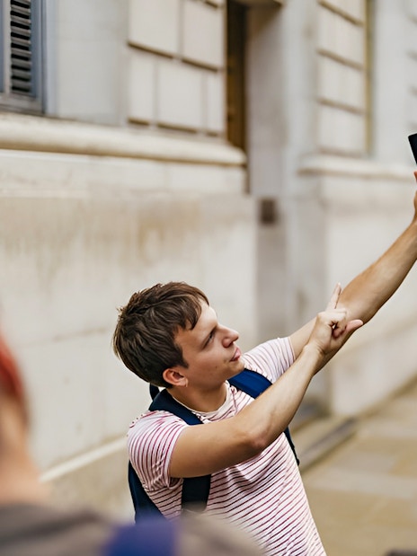 Tour guide leading Harry Potter film locations walking tour in London street.