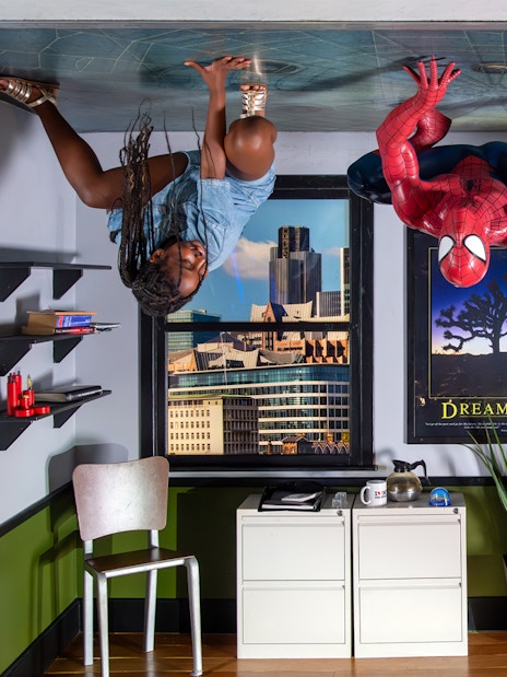 Spiderman wax figure at Madame Tussauds London with tourists taking photos.