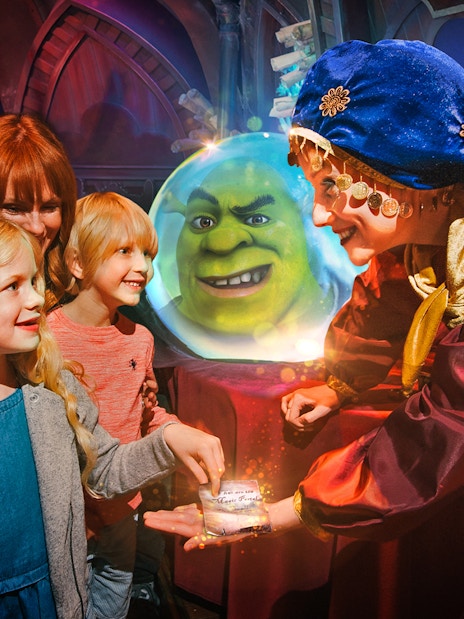 Visitors enjoying interactive Shrek's Adventure tour in London, featuring fun-filled activities and characters from the movie