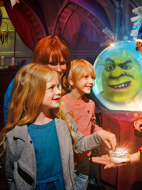 Visitors enjoying interactive Shrek's Adventure tour in London, featuring fun-filled activities and characters from the movie