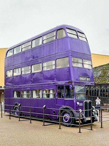 Knight Bus exhibit at Harry Potter London tours with iconic triple-decker purple bus.