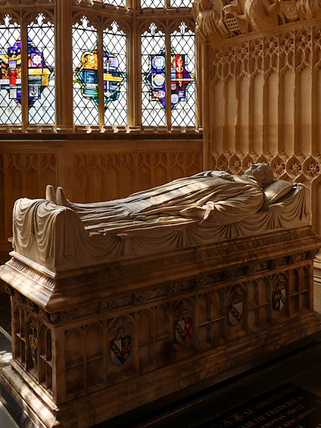 Tomb inside Westminster Abbey with intricate stone carvings, London.